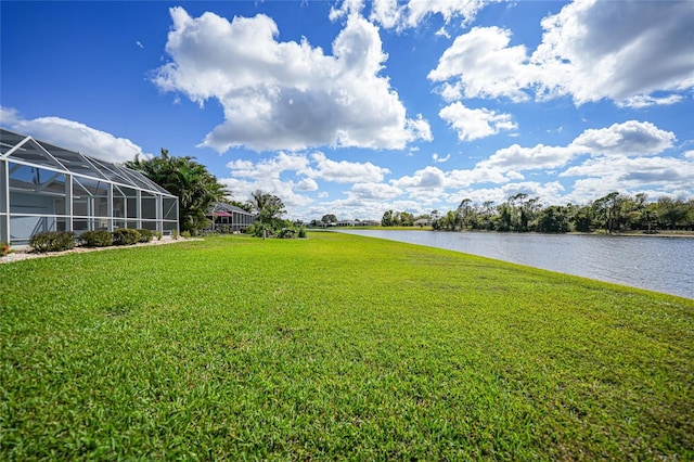 view of yard featuring a water view and a lanai