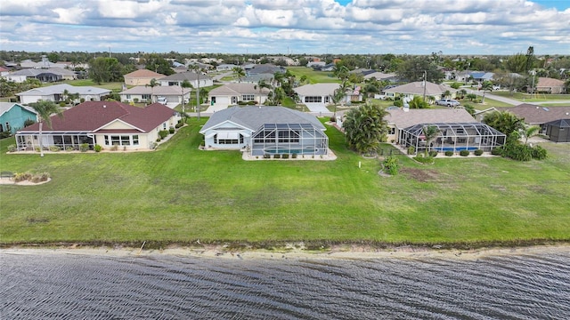 drone / aerial view with a water view and a residential view