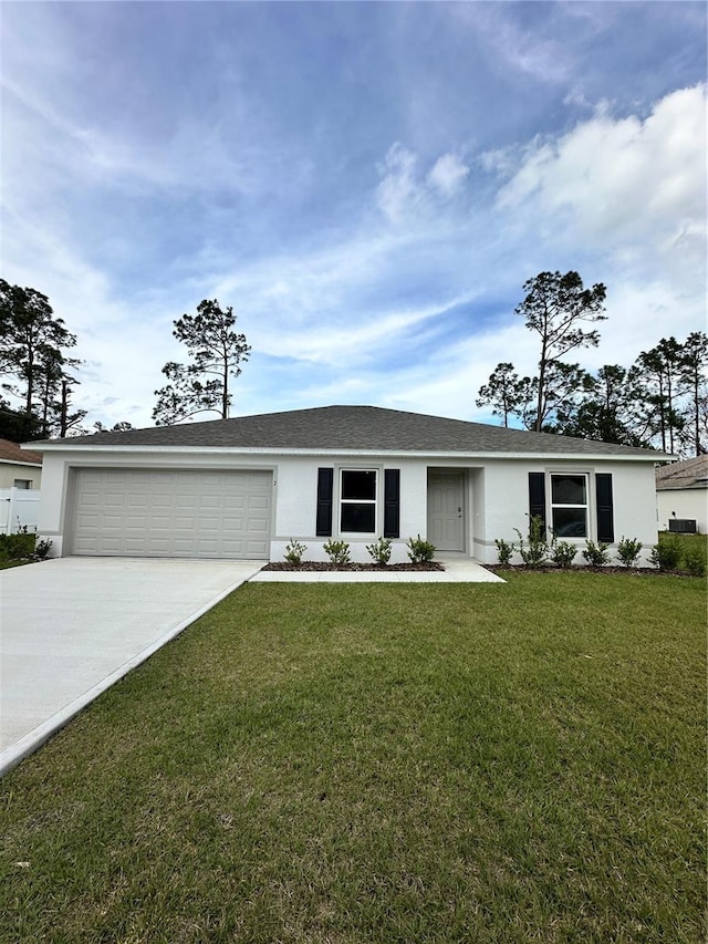 ranch-style house featuring a garage, a front yard, driveway, and stucco siding