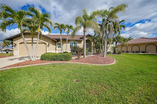 view of front of home with a garage, a front yard, driveway, and stucco siding