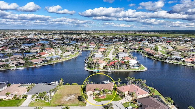 birds eye view of property with a residential view and a water view