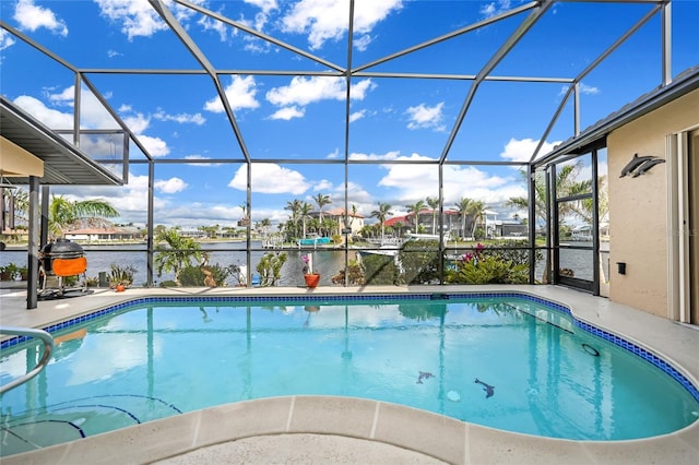 outdoor pool featuring a patio area, a lanai, and a water view