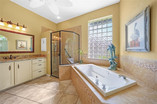 bathroom with a shower stall, vanity, a bath, and a healthy amount of sunlight