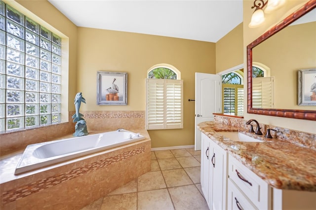 bathroom featuring vanity, plenty of natural light, tile patterned flooring, and a bath