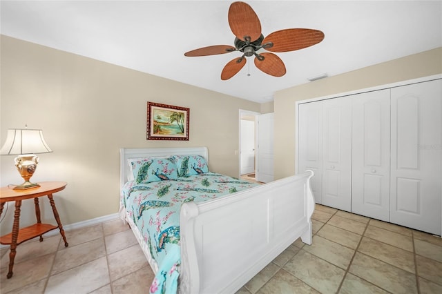 bedroom with light tile patterned flooring, a ceiling fan, visible vents, baseboards, and a closet