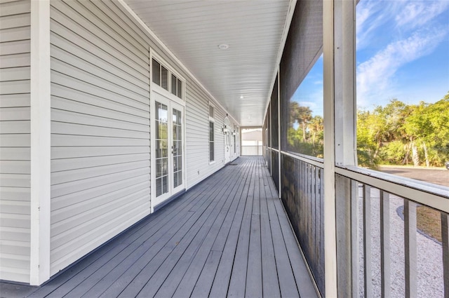 unfurnished sunroom featuring french doors