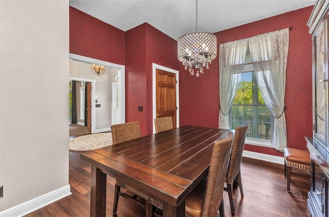 dining room featuring baseboards, a chandelier, and dark wood finished floors