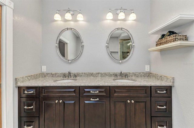 full bathroom featuring double vanity and a sink