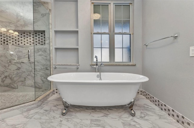 full bath featuring a soaking tub, marble finish floor, a marble finish shower, and baseboards
