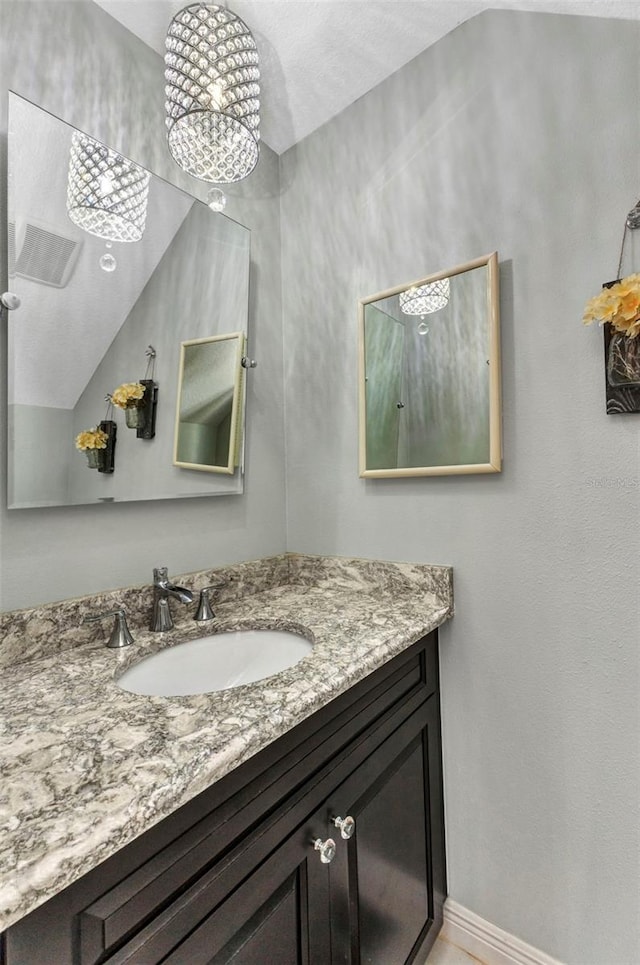 bathroom with vanity and baseboards