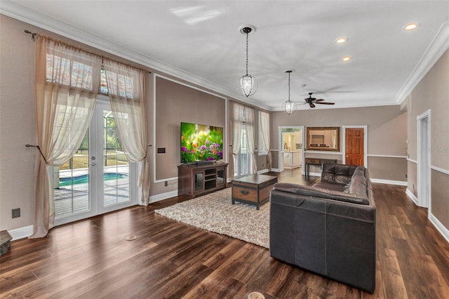 living room with baseboards, dark wood-style floors, ceiling fan, and crown molding