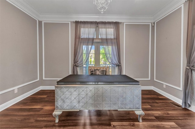details featuring ornamental molding, baseboards, a chandelier, and wood finished floors
