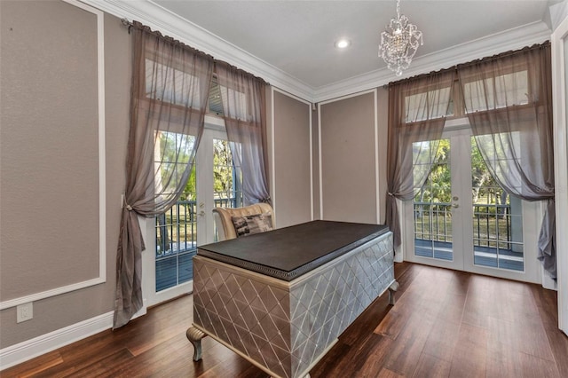 office area featuring a notable chandelier, crown molding, a healthy amount of sunlight, and dark wood finished floors