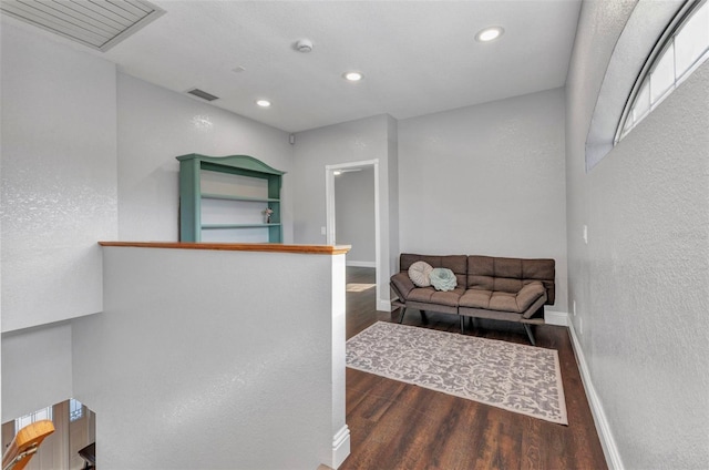 interior space with wood finished floors, baseboards, and visible vents