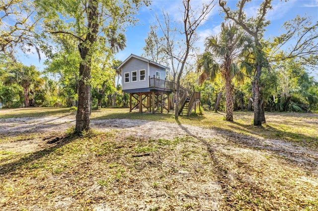 view of yard featuring stairway and a deck