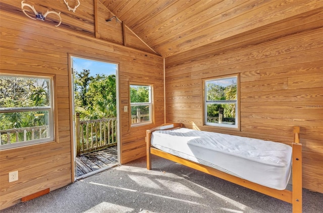 carpeted bedroom with access to exterior, wood ceiling, lofted ceiling, and wooden walls