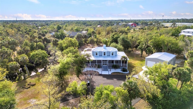 birds eye view of property featuring a view of trees