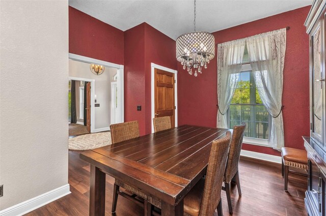 5601 Taylor Rd, Punta Gorda, FL 33950 - dining room with a chandelier, dark wood finished floors, baseboards, and a textured wall