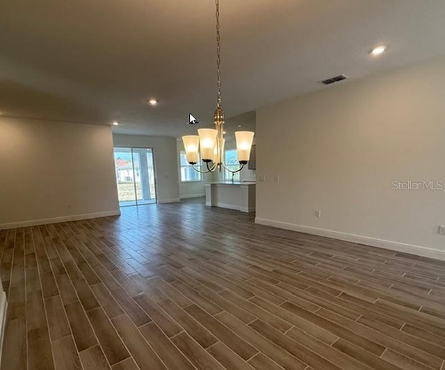 interior space with dark wood-style flooring, recessed lighting, visible vents, and baseboards