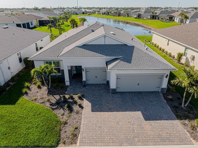 bird's eye view featuring a water view and a residential view