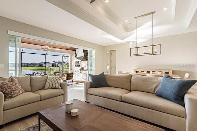 living room featuring ornamental molding, recessed lighting, a raised ceiling, and wood finished floors