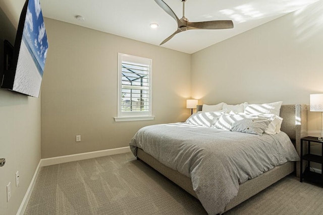 carpeted bedroom with ceiling fan and baseboards