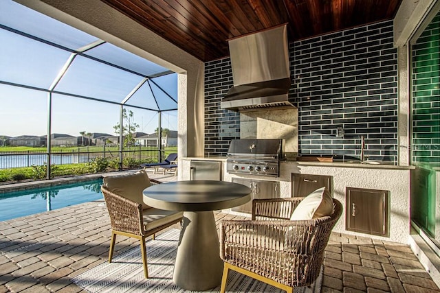 view of patio with grilling area, area for grilling, a sink, a lanai, and an outdoor pool