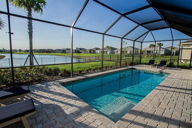 outdoor pool with a water view, glass enclosure, a residential view, and a patio