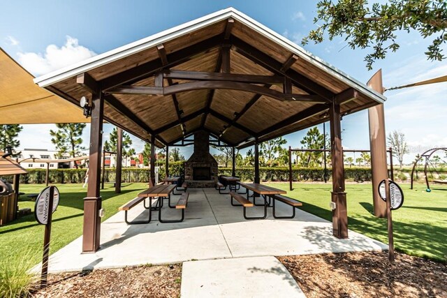 view of property's community with a gazebo, a lawn, and a patio area