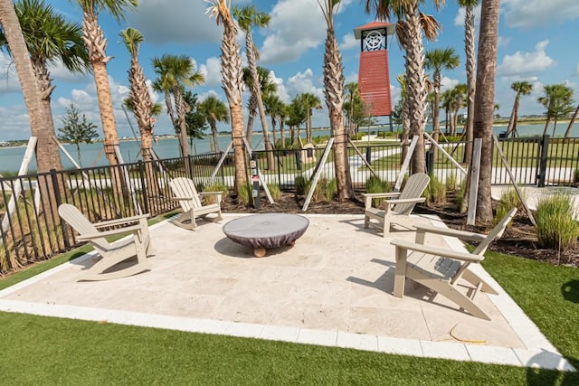 view of patio / terrace with a water view and fence