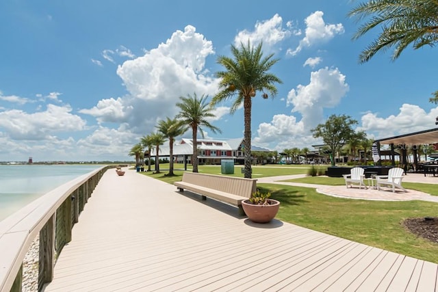 view of dock featuring a water view and a yard