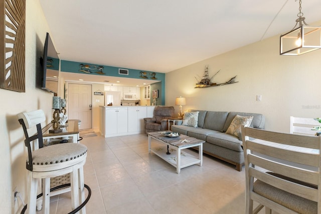 living area with light tile patterned floors and visible vents