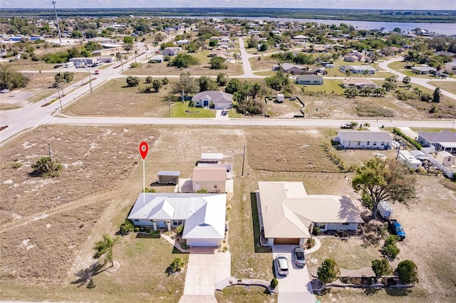 bird's eye view featuring a water view and a residential view