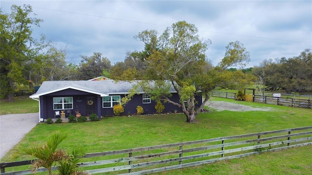 view of yard with a fenced front yard and driveway