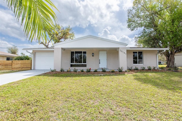 ranch-style house with driveway, an attached garage, fence, a front lawn, and brick siding