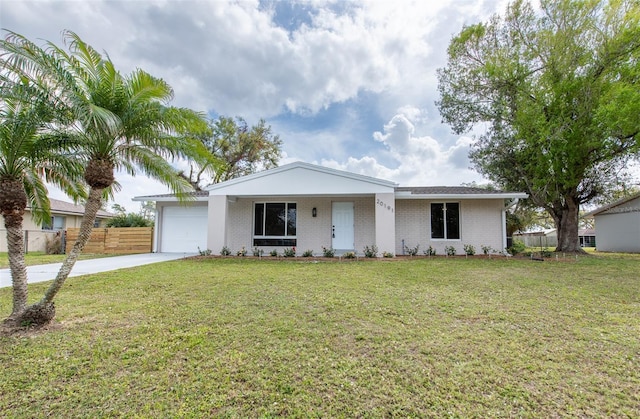 single story home with a garage, brick siding, fence, driveway, and a front yard