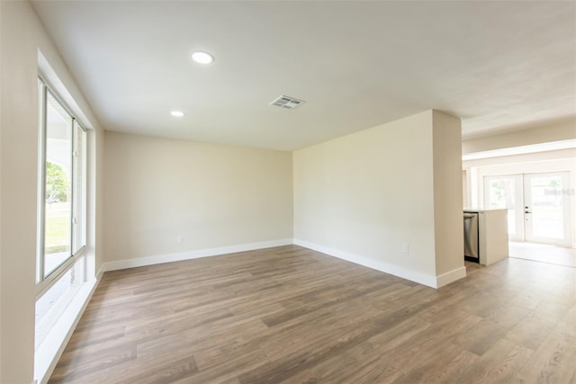 spare room with recessed lighting, baseboards, visible vents, and light wood finished floors