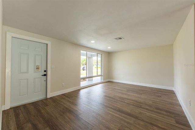 unfurnished room with dark wood-style flooring, recessed lighting, visible vents, and baseboards