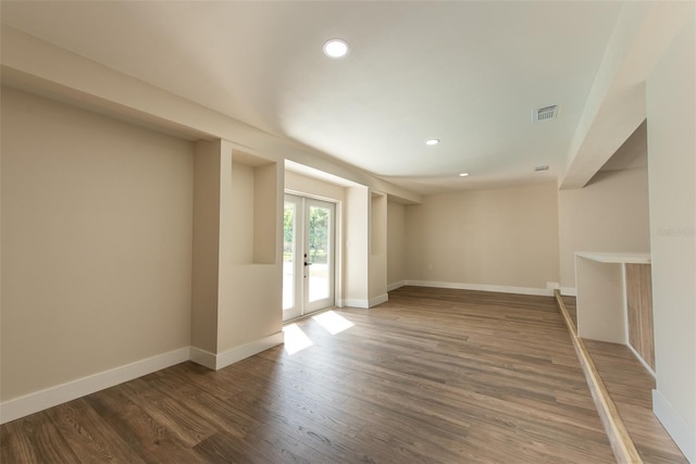 spare room with french doors, recessed lighting, visible vents, wood finished floors, and baseboards