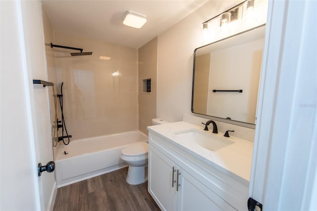 bathroom with toilet, shower / washtub combination, wood finished floors, and vanity