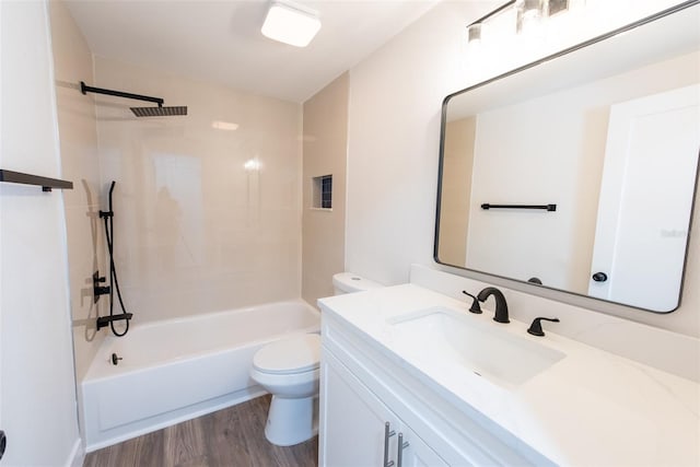 bathroom featuring shower / bathing tub combination, vanity, toilet, and wood finished floors