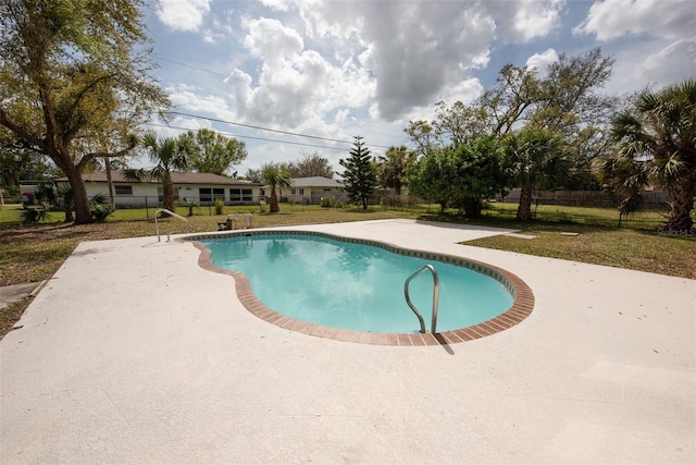 view of swimming pool featuring a lawn, a patio area, fence, and a fenced in pool