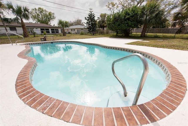 view of pool featuring a fenced in pool, a fenced backyard, and a lawn