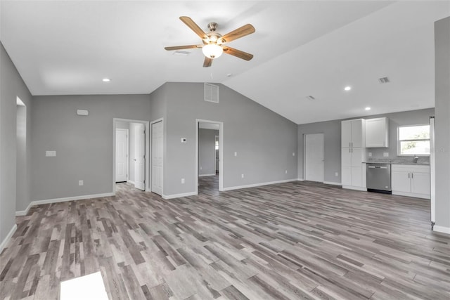 unfurnished living room with visible vents, baseboards, lofted ceiling, light wood-style flooring, and ceiling fan