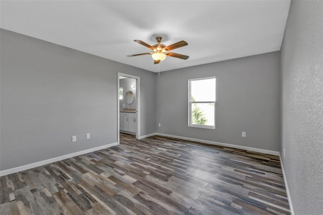 empty room with ceiling fan, baseboards, and wood finished floors