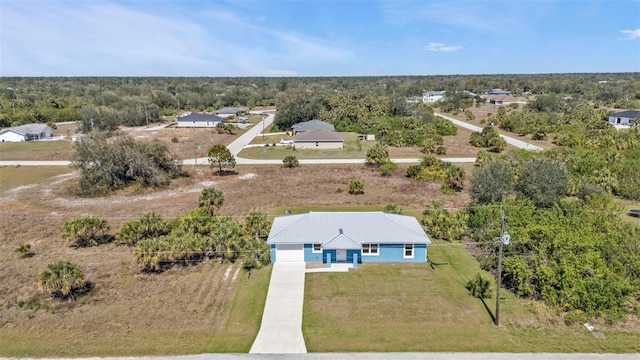 drone / aerial view with a wooded view