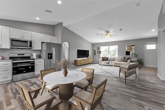 dining space featuring light wood-type flooring, ceiling fan, visible vents, and recessed lighting