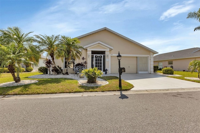 view of front of house featuring a garage, concrete driveway, a front lawn, and stucco siding