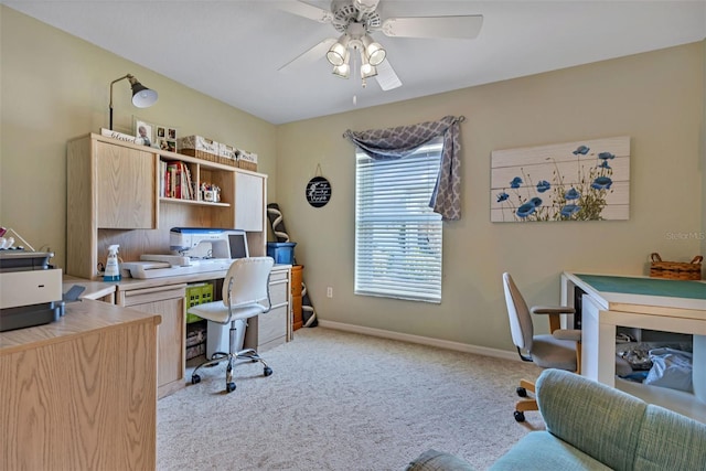 office area with light colored carpet, ceiling fan, and baseboards