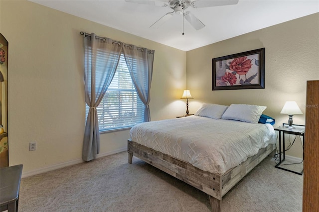 bedroom with baseboards, a ceiling fan, and light colored carpet